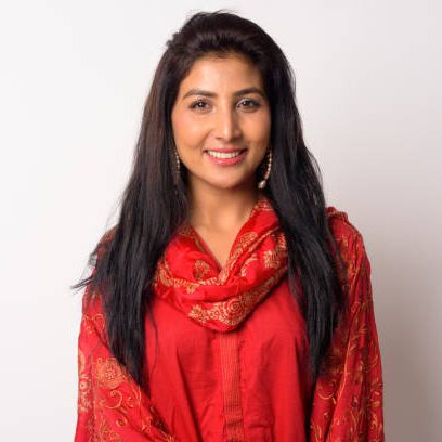 Studio shot of young beautiful Persian woman wearing traditional clothing against white background